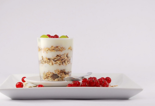 Yogurt with granola and fruit.